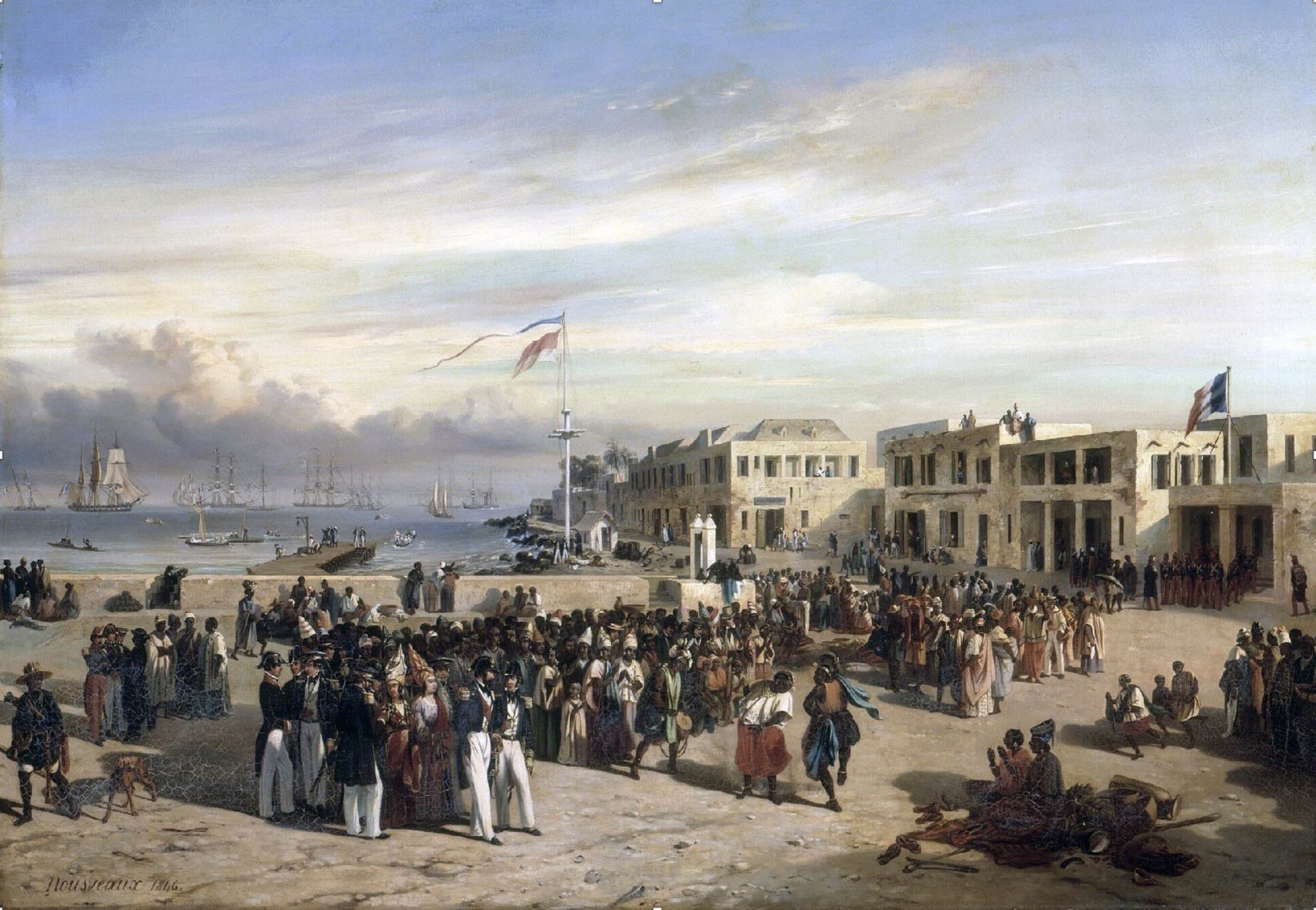 A large diverse crowd gathered on a coastal area with several ships visible on the sea in the background, a French flag is displayed on a pole.