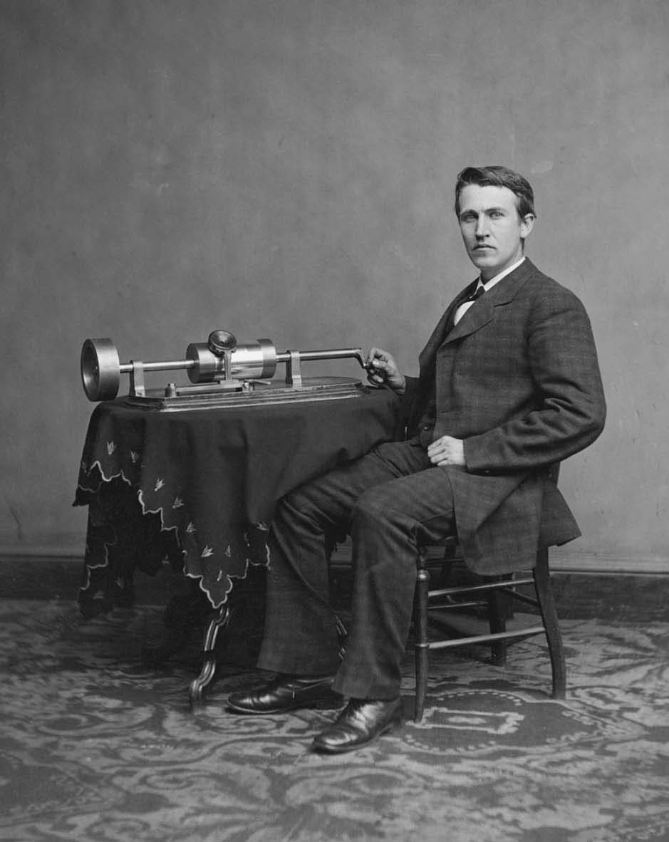 A photograph of Thomas Edison operating an electric device