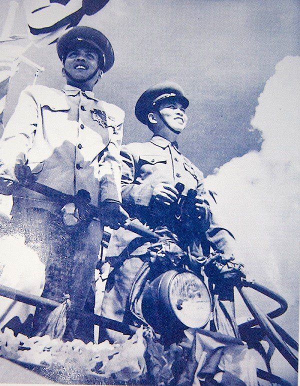 A black and white photograph of two Vietnamese officers. Both men are smiling.