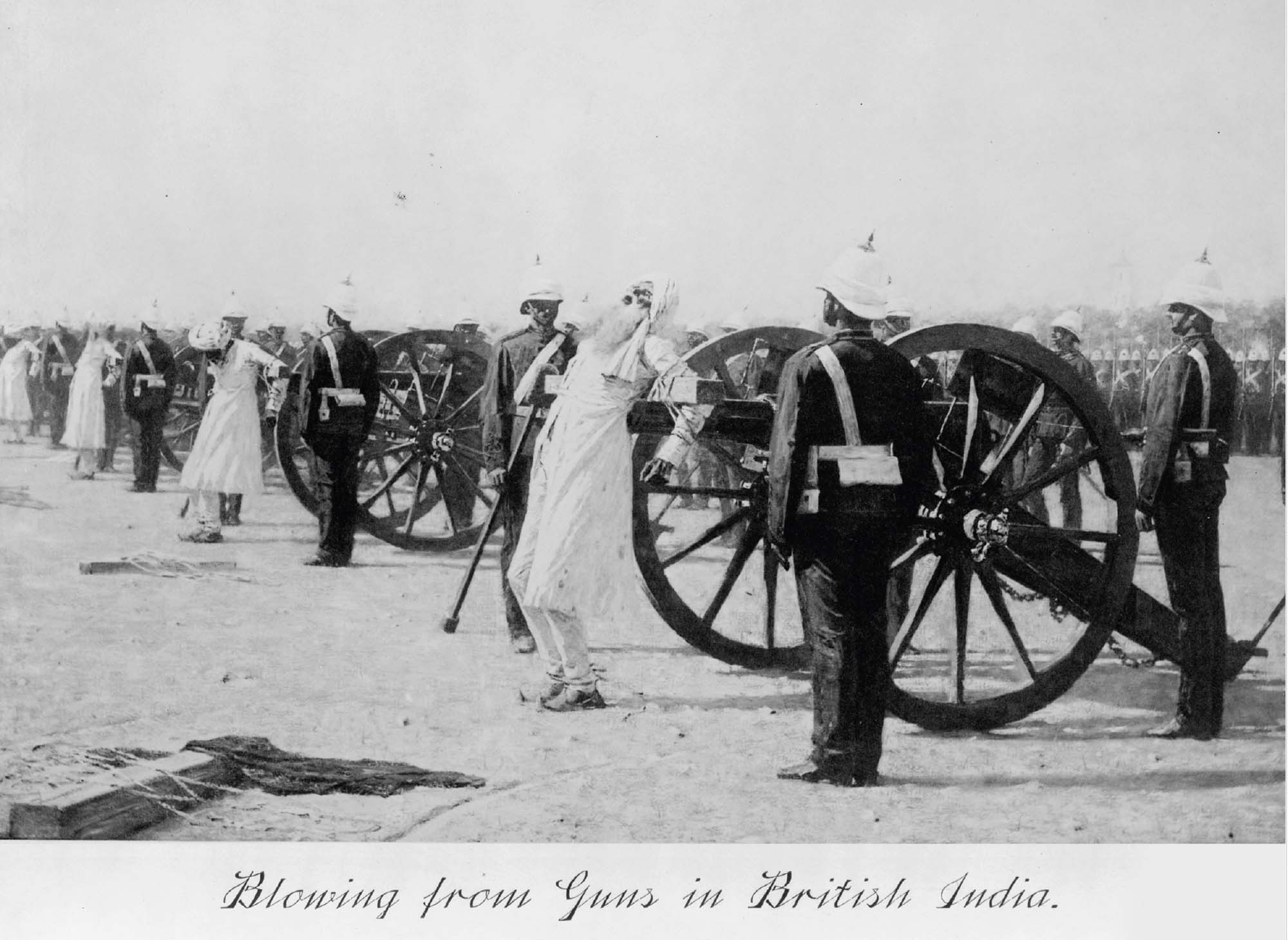 Photo of British soldiers performing executions. In the photo, those sentenced to death are shown strapped to the barrel of a large cannon.  