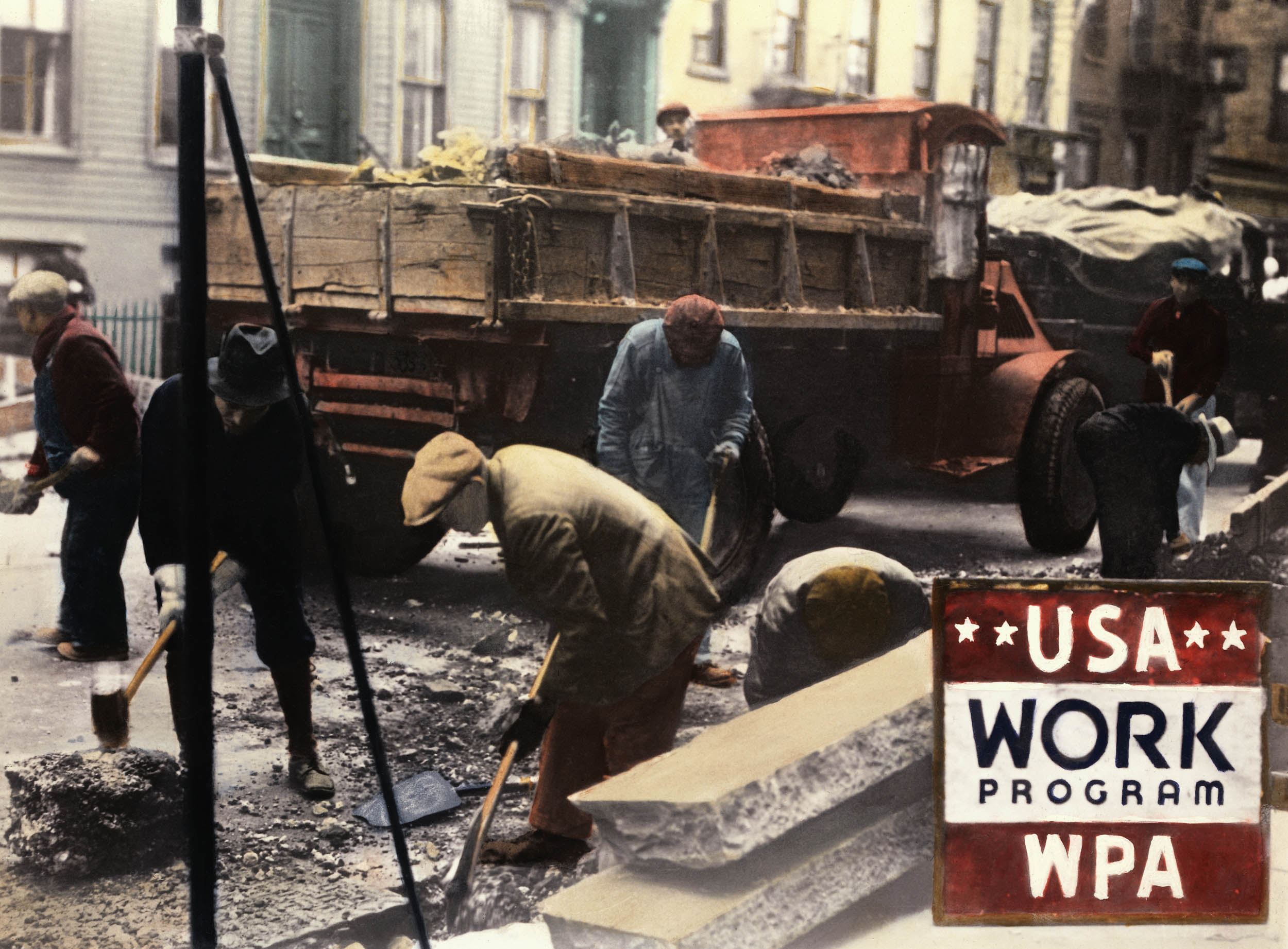 Colorized photo of workers breaking pavement with sledgehammers near a dump truck on a city street, with a “USA Work Program WPA” sign in the foreground.