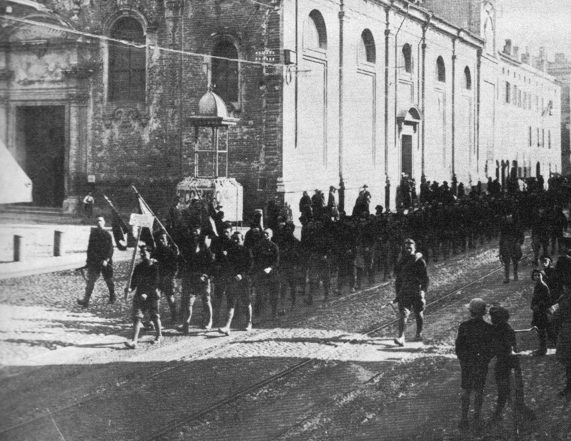 Photo of the fascist military forces known as the Blackshirts marching down an Italian street in Parma.