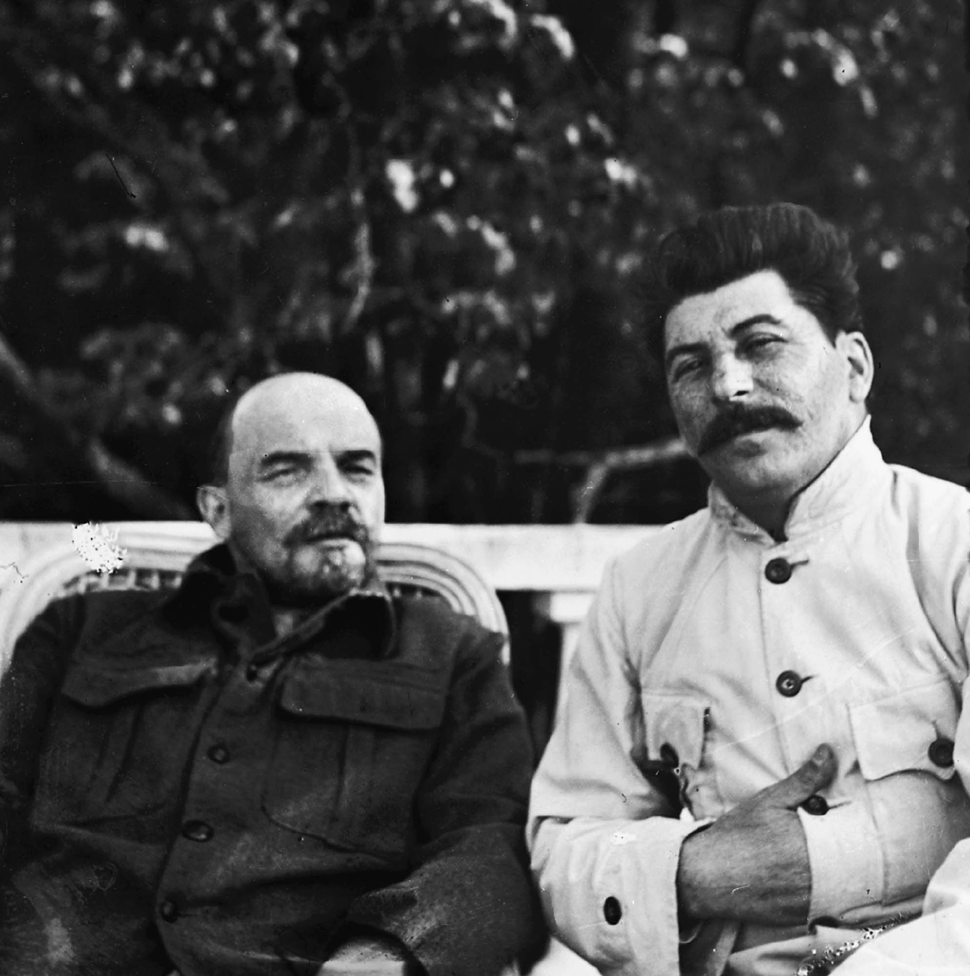 Photo of Vladimir Lenin and Joseph Stalin sitting next to each other outside.