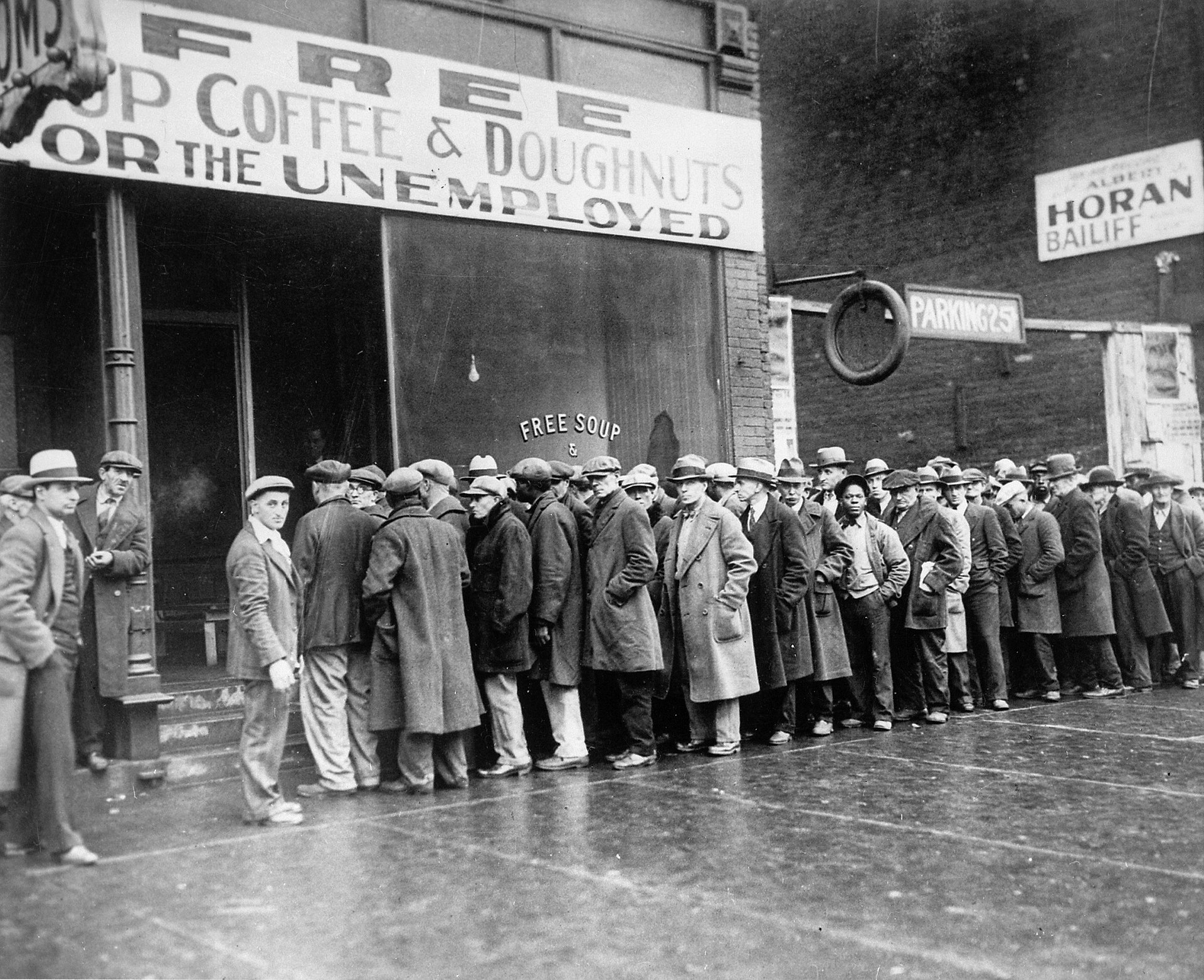 A photograph shows unemployed men lined up, many with hands in their pockets. The storefront sign reads "Free Soup Coffee & Doughnuts for the Unemployed."