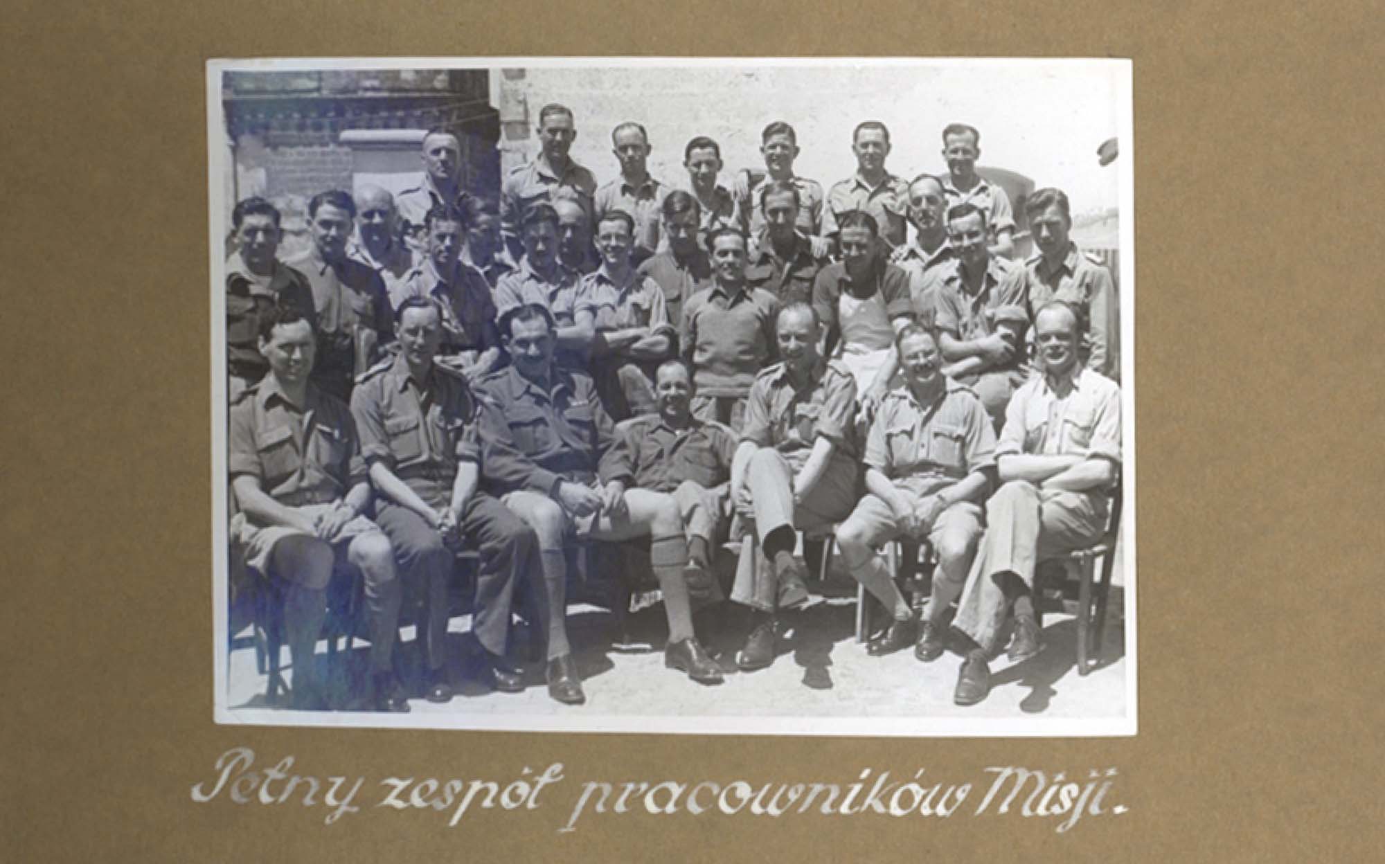 A photograph of several smiling, seated officers.