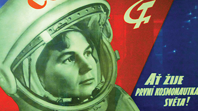 Colorful propaganda poster of a Russian astronaut in looking at a rocket in the sky, the Soviet hammer-and-sickle symbol in its wake.