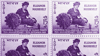 Photo of four stamps that show Eleanor Roosevelt using a spinning wheel. “Universal Declaration of Human Rights 15th Anniversary – 10th December 1963” is written at the bottom.